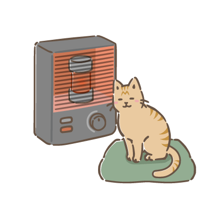 ストーブの前で暖まる猫